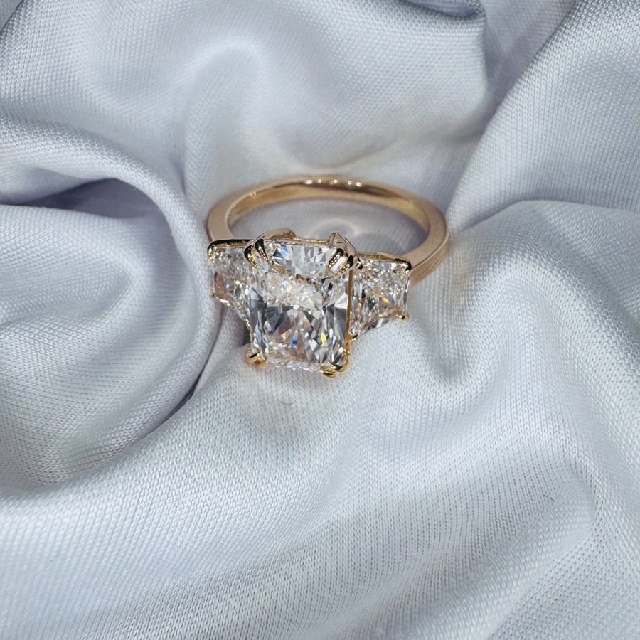 Diamond engagement ring photographed on silver satin